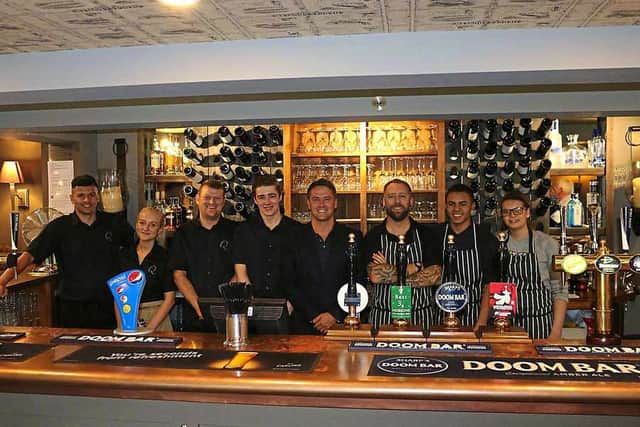 Delighted staff at the Queens at Horton with footballing ace Michael Owen