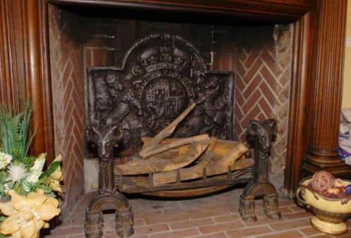 The historic fireplace with distinctive herringbone brickwork