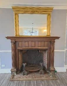 The historic fireplace, featuring distinctive herringbone brickwork