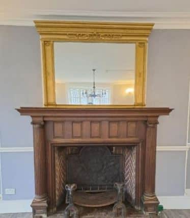 The historic fireplace with distinctive herringbone brickwork