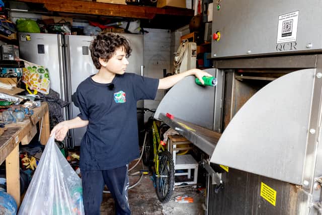Ryan Hulance, who started We Can CIC (Community Interest Company) - an initiative to collect cans to help good causes, puts a can into a crusher in his garage at home in Solihull, West Midlands.