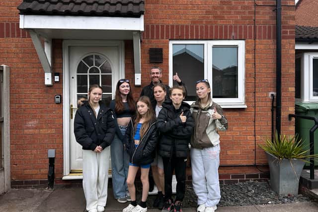 The Deeming-Thomas family outside their modest home in Stafford