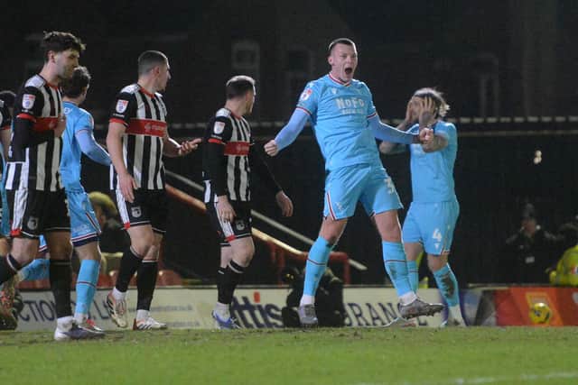Kacper Lopata celebrates Priestley Farquharson's opener for Walsall.