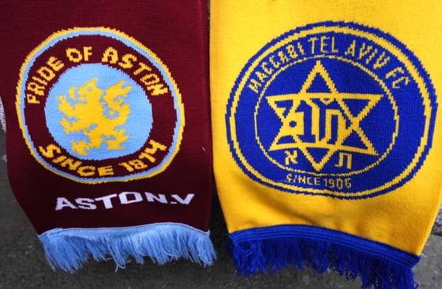 Aston Villa and Maccabi Tel Aviv club badges on a scarf.