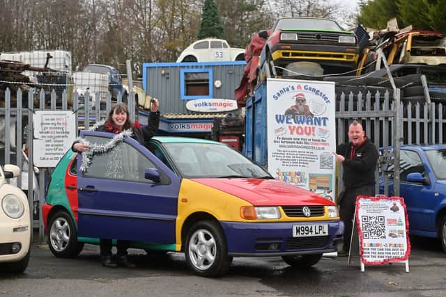 Volksmagic's Lee Southerton hands over the keys to Nessy the Car to the 'Santa is a Gangsta' competition winner: Jane Davies from Penn.