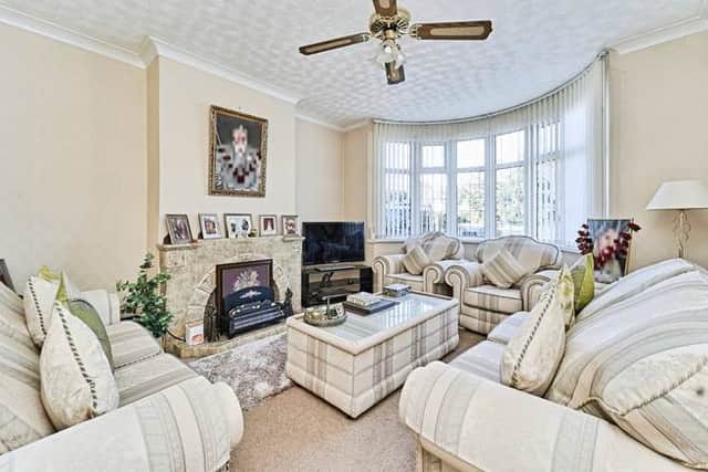 A bright front lounge with a bay window and central fireplace, ideal for everyday living and relaxing