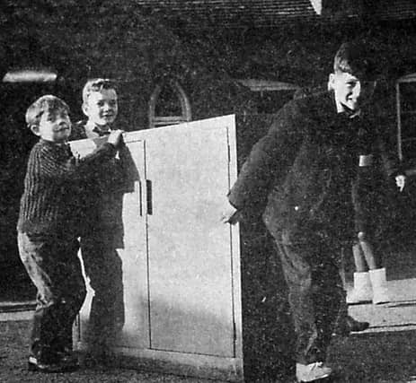 St Mary's Bluecoat CofE School, Hospital Street, Bridgnorth, pictured on Tuesday, December 7, 1965 - the day it was evacuated following the architect's report. The caption: 'Moving out day. Pupils help to move furniture out of the 'slum' school.'