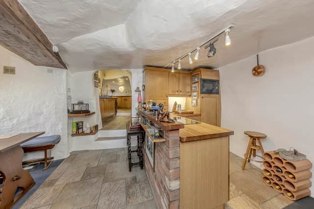 A stunning 16th-century West Midlands cottage built into a carved-out cave has gone on sale .