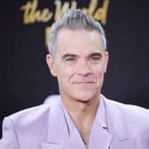 Robbie Williams says he is happy with life and enjoying his music