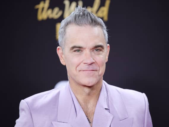 Robbie Williams says he is happy with life and enjoying his music