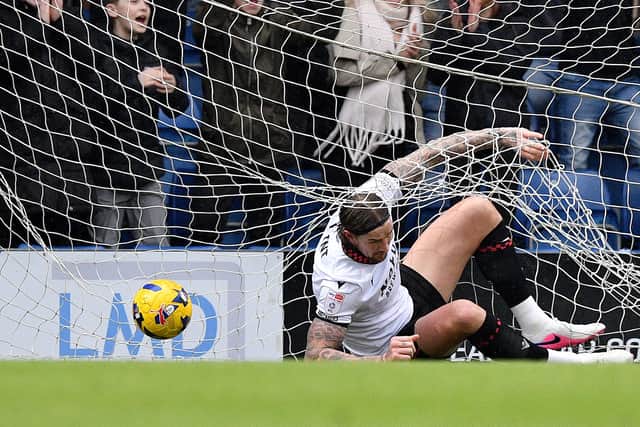 Aden Flint can't stop the ball from hitting the back of the net as Chesterfield make it 2-0.
