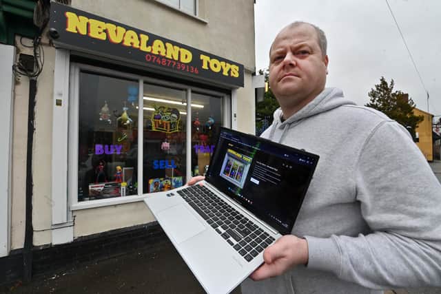 Nevaland Toys in Halesowen, a new shop run by Jonathan Hughes who appears to bethe victim of business identity theft. 
He is pictured with the fake web site on his laptop, and on some paperwork showing how his business has been registered, supposedly from a Ghanaian man.