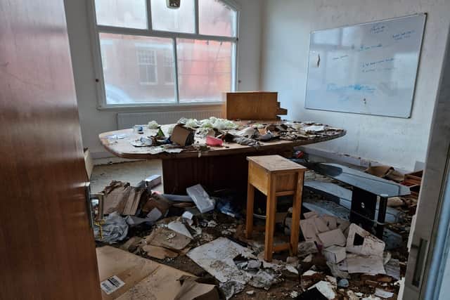 The conference room is covered in debris
