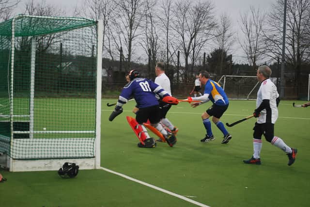 Stourport men's Masters pressure Litchfield goal.