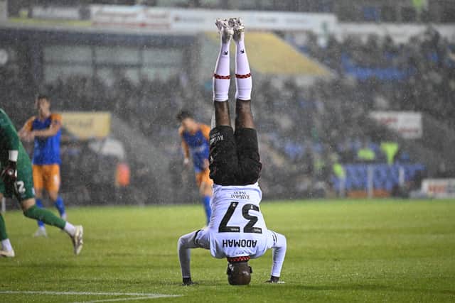 Walsall attacker Albert Adomah celebrating his 100th club career goal in a group stage win at Shrewsbury. (Image by Owen Russell)