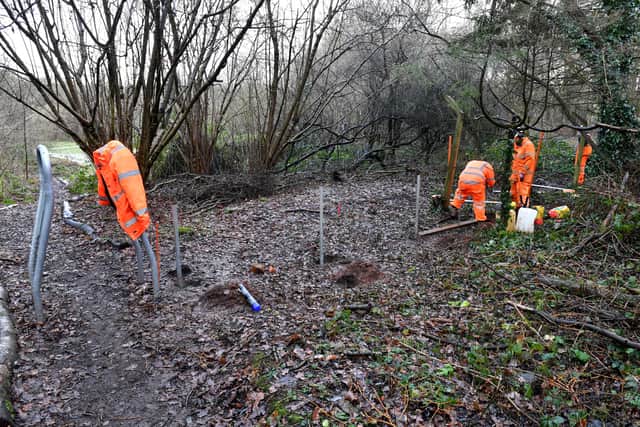 Workers install the low barriers on the nature reserve