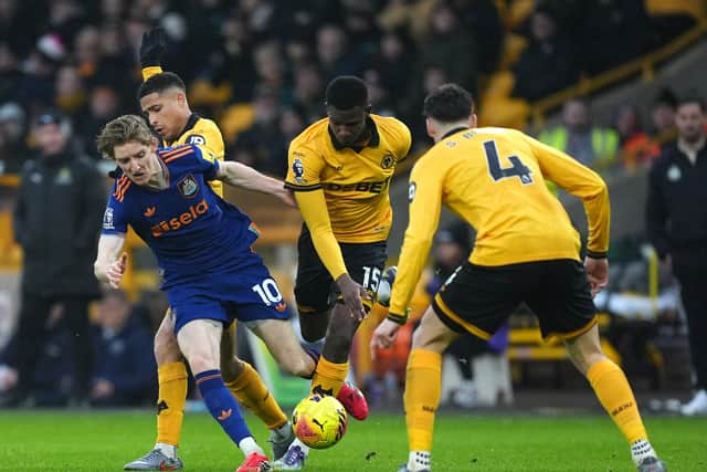 Newcastle United's Anthony Gordon is challenged by Wolves' Joao Gomes and Yerson Mosquera. Picture: PA