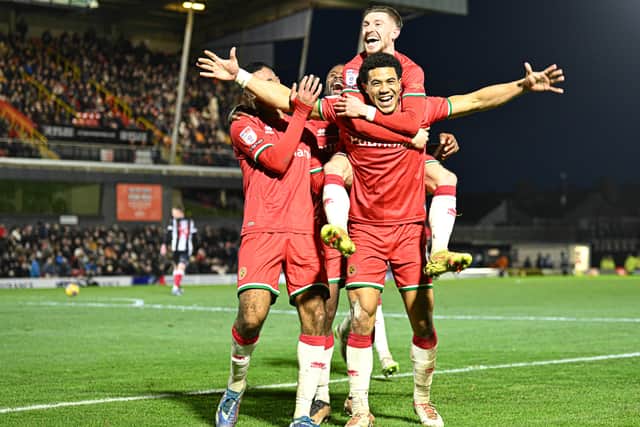 Walsall celebrate their 6-1 victory at Grimsby Town on New Year's Day in 2024.