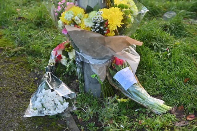 Tribute of flowers and balloons were left at the scene of a murder