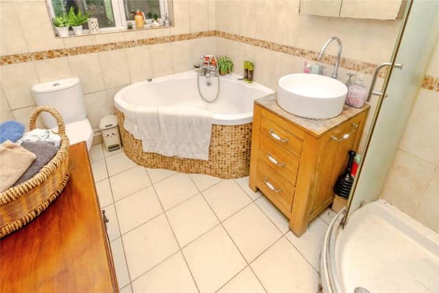 The spacious bathroom with shower unit