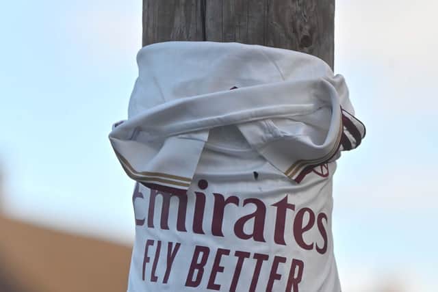 Friends have adorned street furniture on the victim's street with flowers and mementoes