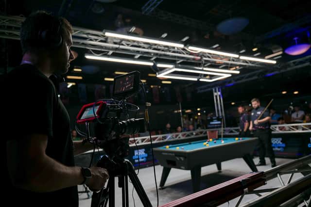 A cameraman films Ultimate Pool
