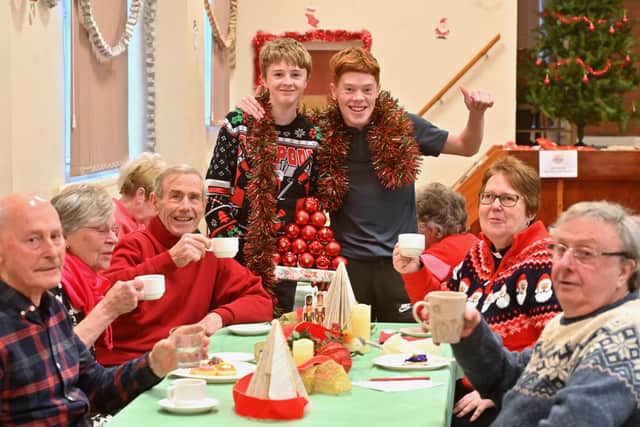 Michael Harris (15) and Ollie Garfield (18) who attended the party in Wordsley. At the table are Paul Barnes, Michael and Sue Haywood, Elaine Garbett and Roger Brown. Photo: Steve Leath