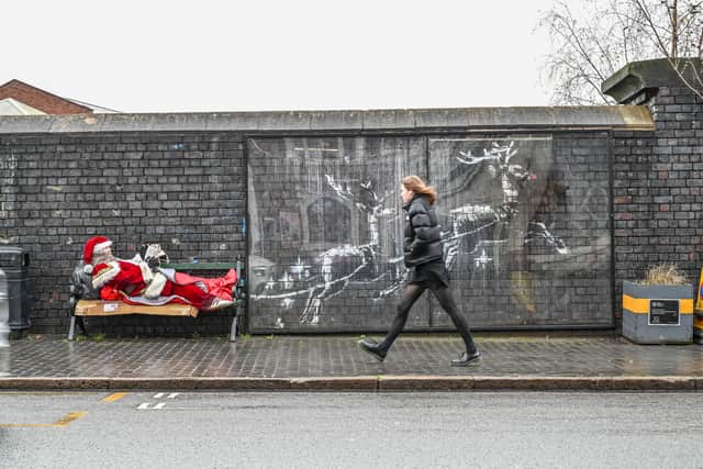 Father Christmas has showed up on a bench in Birmingham's Jewellery Quarter next to the Banksy mural. December 17 2025.