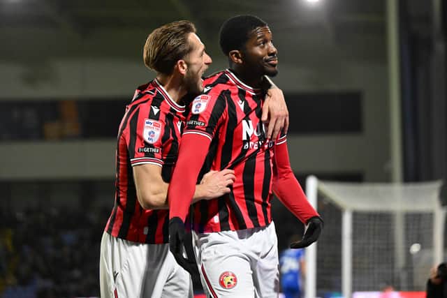 Lakin celebrates with goal scorer Kanu.