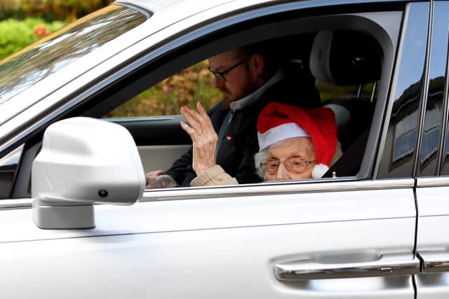 Dorcas Dearne gives a regal wave as she sets off in a Rolls Royce. Photo: Tim Thursfield