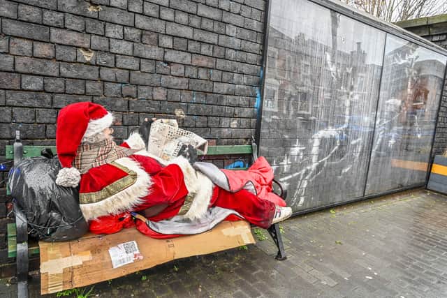Father Christmas has showed up on a bench in Birmingham's Jewellery Quarter next to the Banksy mural. December 17 2025.