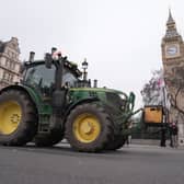A tractor being driven past Big Ben