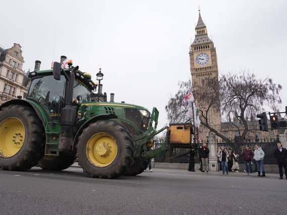 A tractor being driven past Big Ben