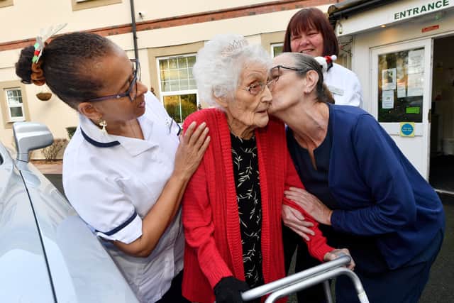 Dorcas Dearne receives a kiss from The Cedars nursing home manager Christina Spain before her trip. Photo: Tim Thursfield