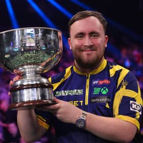 Littler lifts the trophy after winning the Grand Slam of Darts final in Wolverhampton
