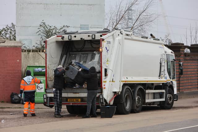 People dispose of their rubbish using a mobile refuse collection service in Drews Lane Ward End, Birmingham. 