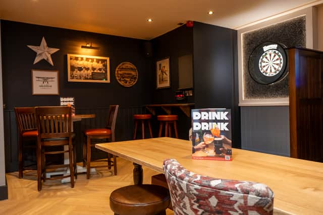 A fully stocked gaming room with new dart board has been set up