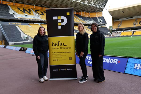TPSquared Team: Harriet Leith - Graphic Designer, Carolyn Smith – Managing Director and Claire Ash - Senior Graphic Designer stood pitchside at the Molineux.