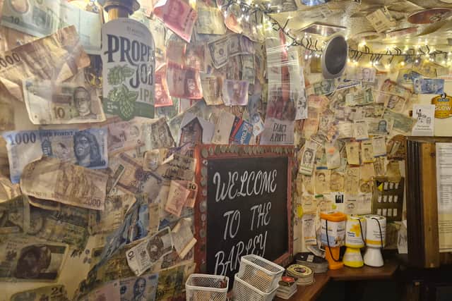 The bar is also covered in notes from around the world