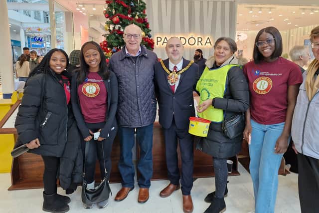 Members of the Rotary Club and Wolverhampton University Rotaract club pose with the Mayor by the tree