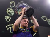 Luke Littler lifts the trophy after winning the Grand Slam of Darts final. Photo: Martin Rickett/PA