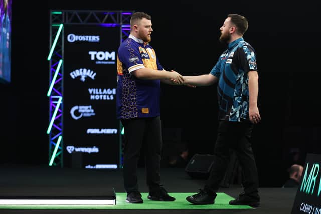 Josh Rock shakes hands with Connor Scutt after their second-round clash at the Mr Vegas Grand Slam of Darts (Picture: Kieran Cleeve/PDC)