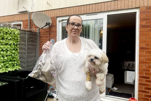 Celine Lockyer with her dog Milo and the egg boxes recovered from an alley after the attack on her Worcester home.