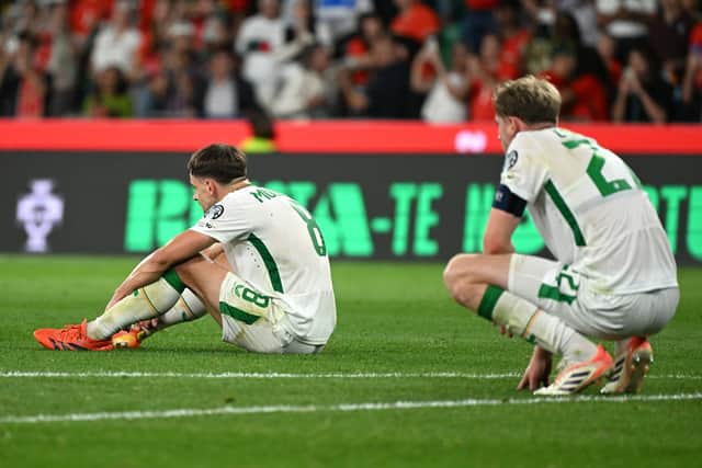 Jayson Molumby, left, despondent after a late defeat to Portugal.