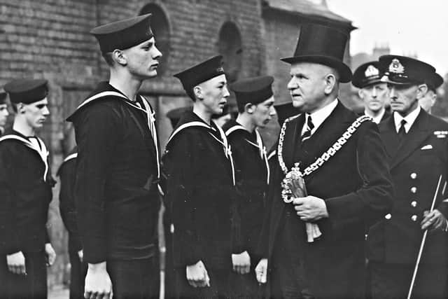 Day of remembrance for the Royal Navy and the Merchant Navy, Darlington Street Methodist Church, Wolverhampton, July 20, 1942. The photograph shows the Mayor of Wolverhampton, Councillor G. Bates, inspecting the Wolverhampton unit of the Sea Cadet Corps, with Lieutenant H. C. Wilson on the right
