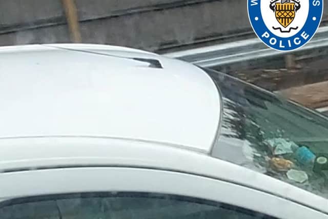 A driver rolling a suspected cannabis joint while driving