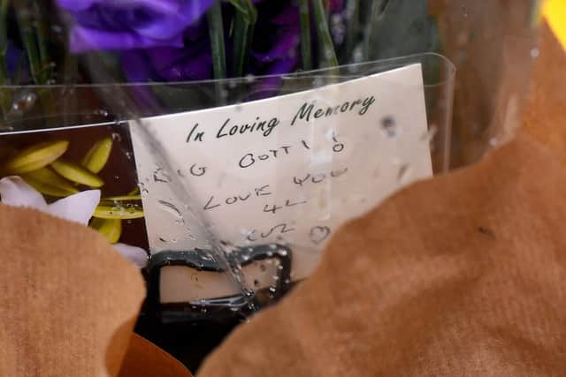 A note was placed with one of the flowers, it reads 'love you cuz'