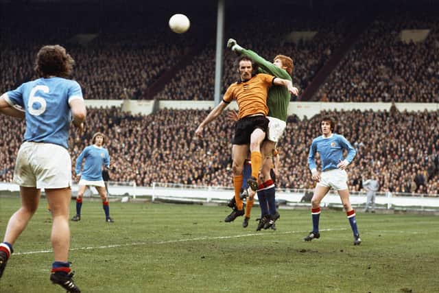 Manchester City goalkeeper Keith MacRae punches clear from the head of Wolves striker Derek Dougan during the 1974 League Cup Final at Wembley Stadium (Photo by Don Morley/Allsport/Getty Images)