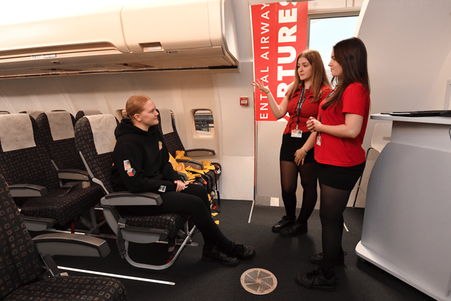 Travel & Aviation students show off the aircraft cabin