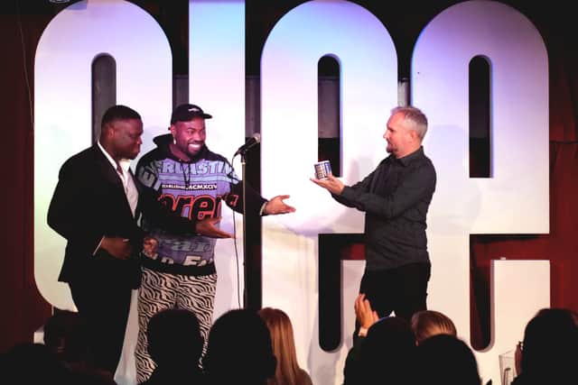 Ryan Lewis receives his award from Darren Harriott and James Cook at the awards